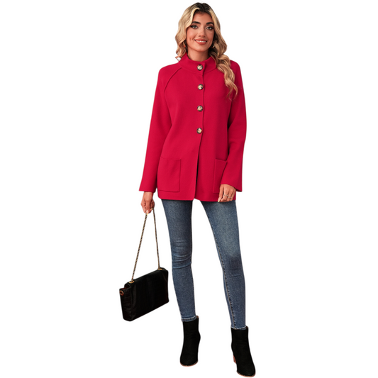 Woman wearing a red coat with gold buttons, holding a black handbag on a white background