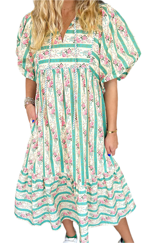 Front view of a multicolor boho floral striped long dress with a tie V-neckline and relaxed fit.