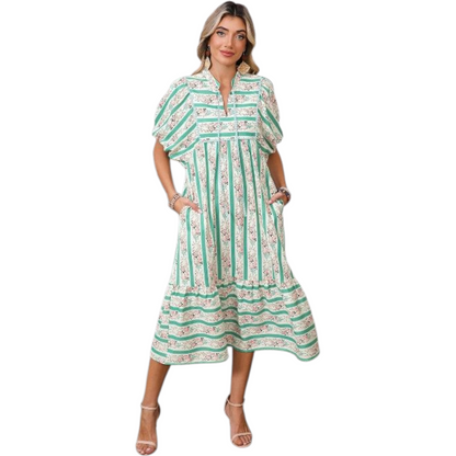 Woman wearing a green and white patterned dress on a white background