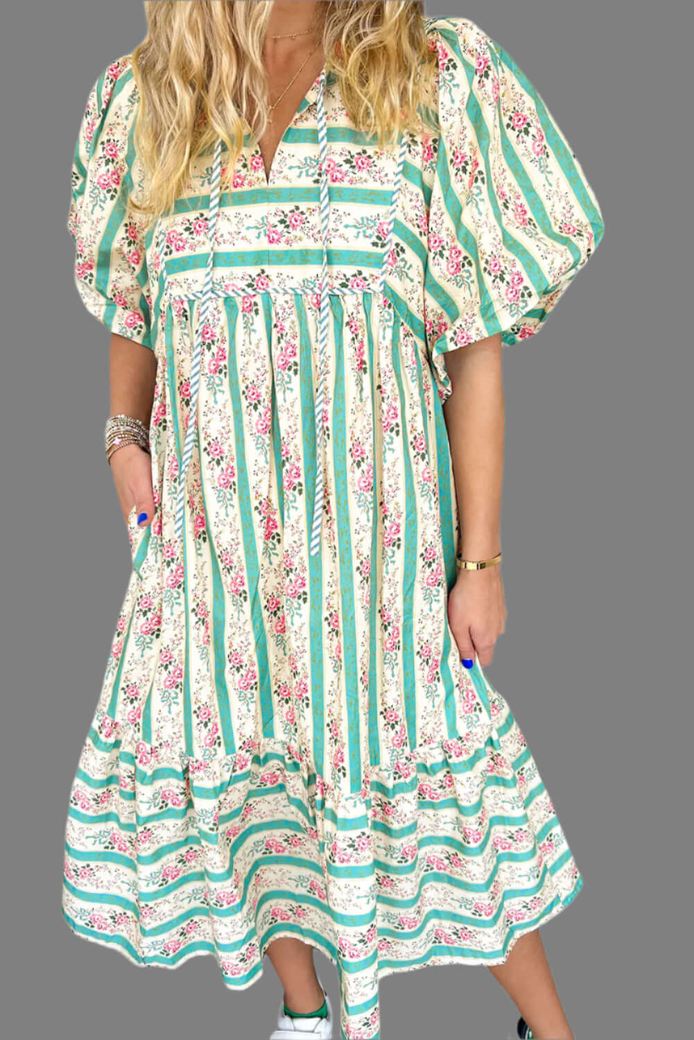 Model standing in a boho floral striped maxi dress, perfect for summer outings.