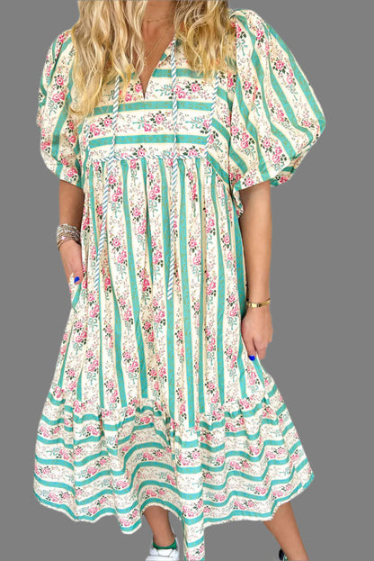 Model standing in a boho floral striped maxi dress, perfect for summer outings.