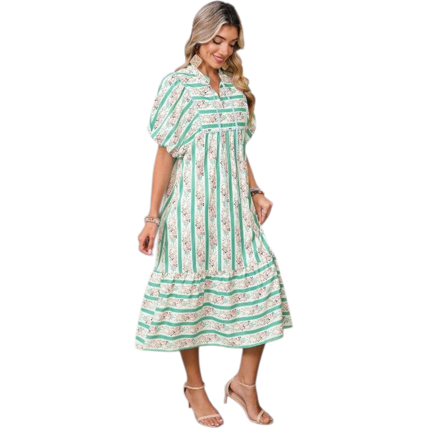 Woman wearing a green and white striped dress with floral patterns on a white background