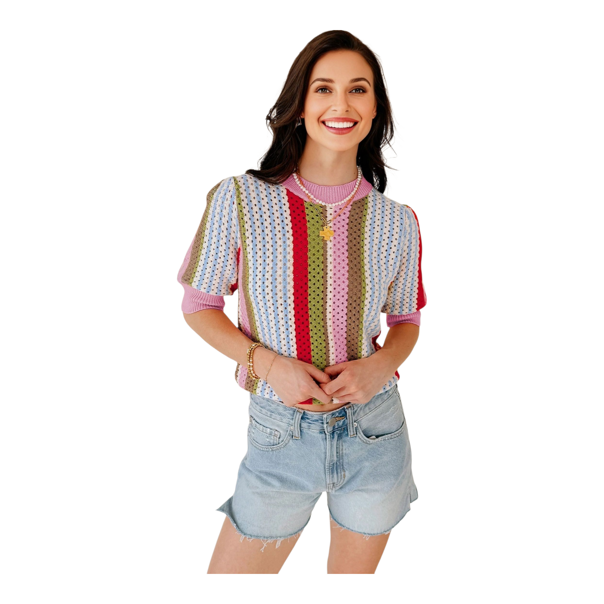 Woman wearing a colorful striped shirt and denim shorts on a white background