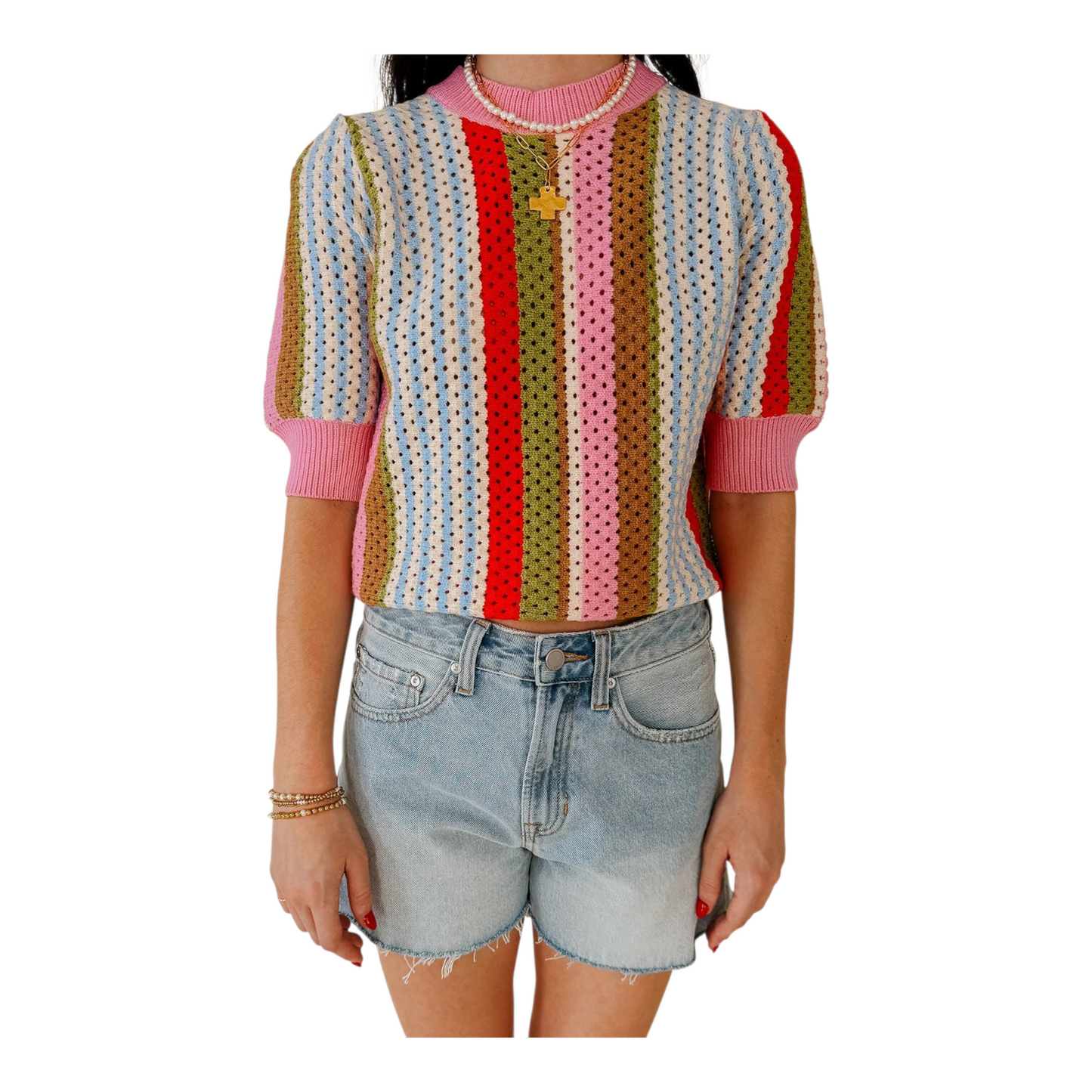 Person wearing a colorful striped sweater and denim shorts on a white background