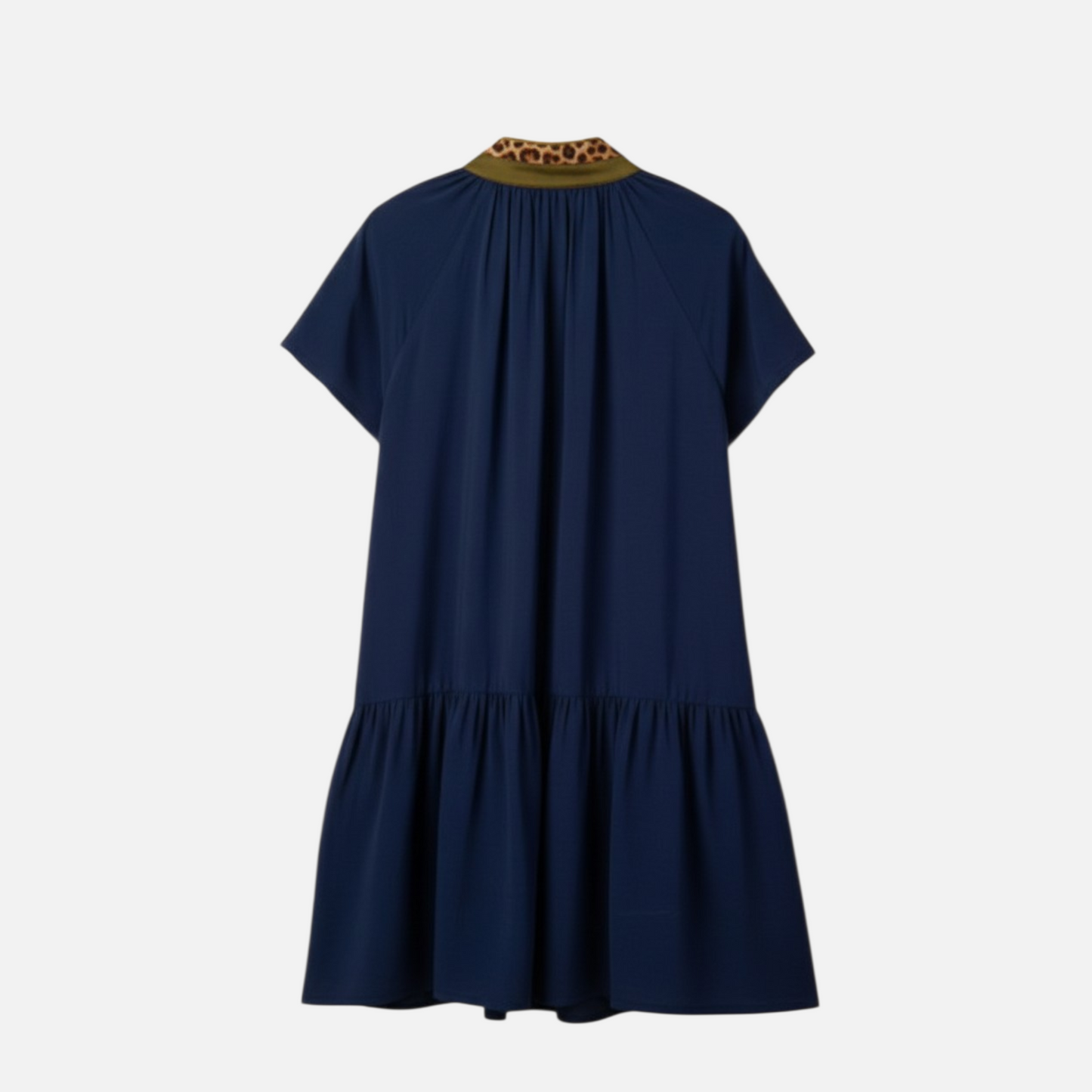 The rear view of a navy shift dress showcasing a relaxed fit and a feminine gathered ruffle hemline in soft, breathable fabric.