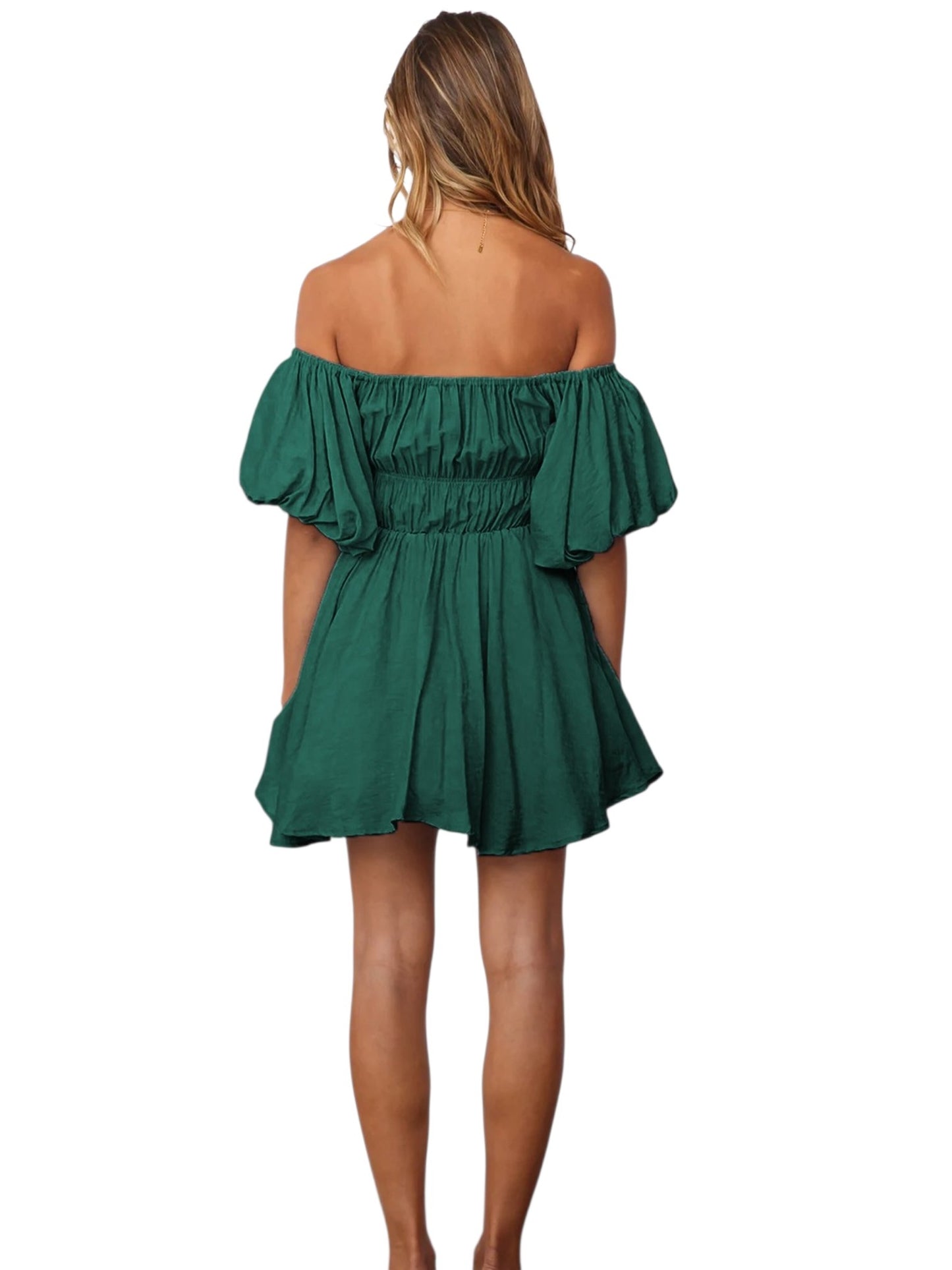 A woman shown from the back wearing a dark green off-the-shoulder mini dress with ruffled sleeves and a gathered waist, photographed against a plain white background.
