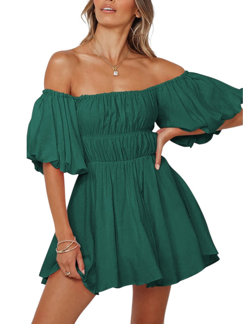 A woman wearing a dark green off-the-shoulder mini dress with ruffled sleeves and a gathered elastic waist, shown against a plain white background.