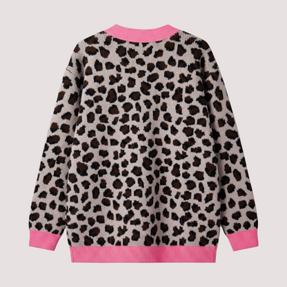 Back view of a button-down leopard print knit cardigan on a hanger, featuring contrast pink ribbed cuffs, hem, and pocket details.