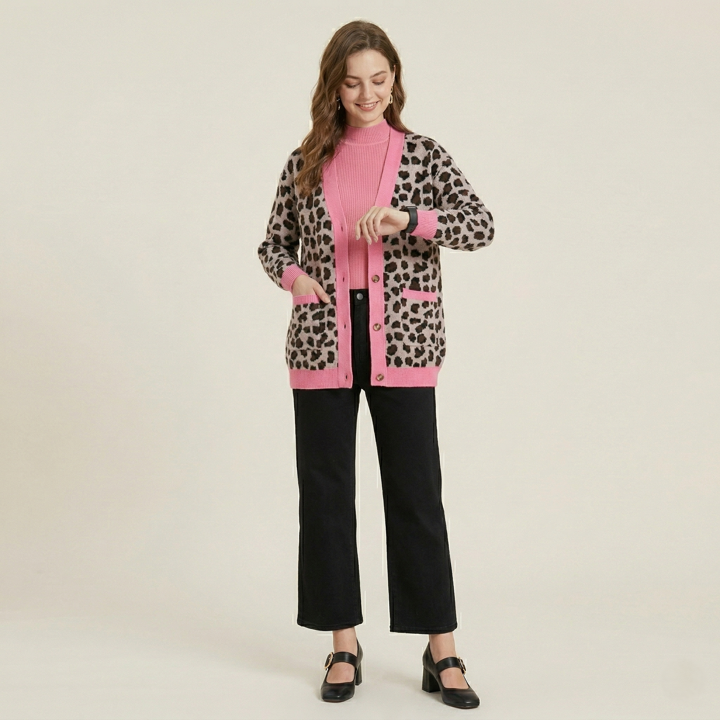 Full-length studio shot of the pink-trimmed leopard cardigan showcasing its relaxed, oversized silhouette and button-down front.