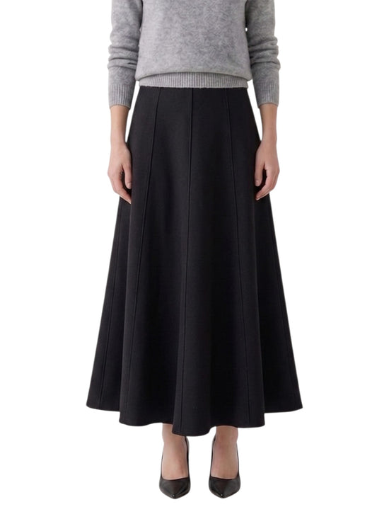 Person wearing a black skirt and gray sweater on a white background