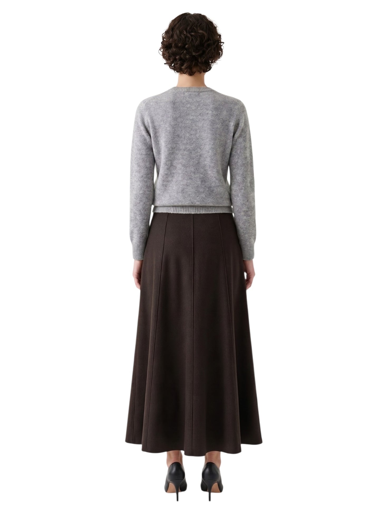Person wearing a gray sweater and brown skirt on a white background
