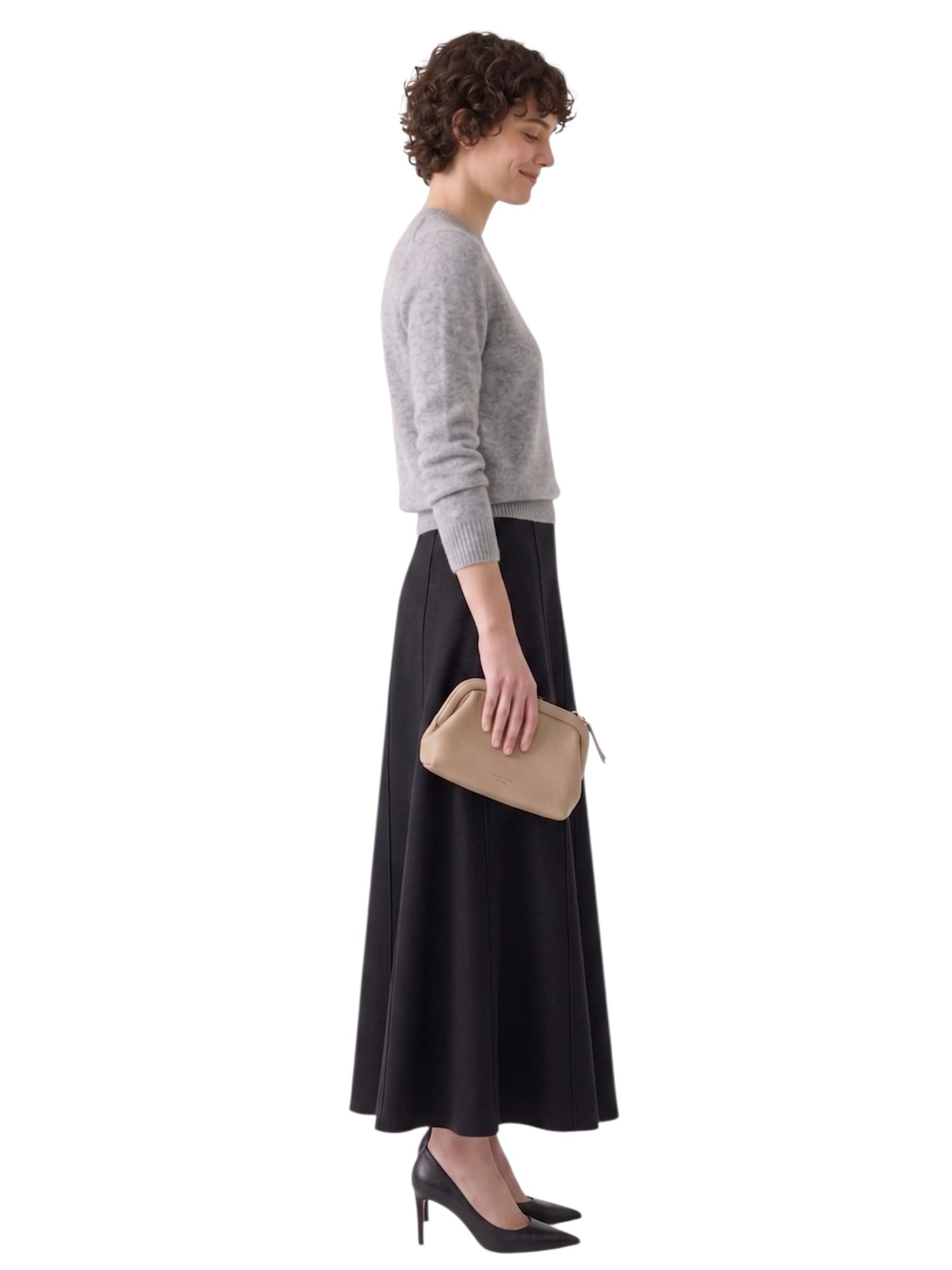 Side-profile view highlighting the elegant flare, clean hip profile, and floor-skimming length of the panelled skirt.