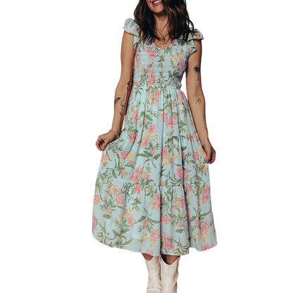 A tiered mint green maxi dress with a pastel floral print, featuring a smocked bodice and ruffled cap sleeves.