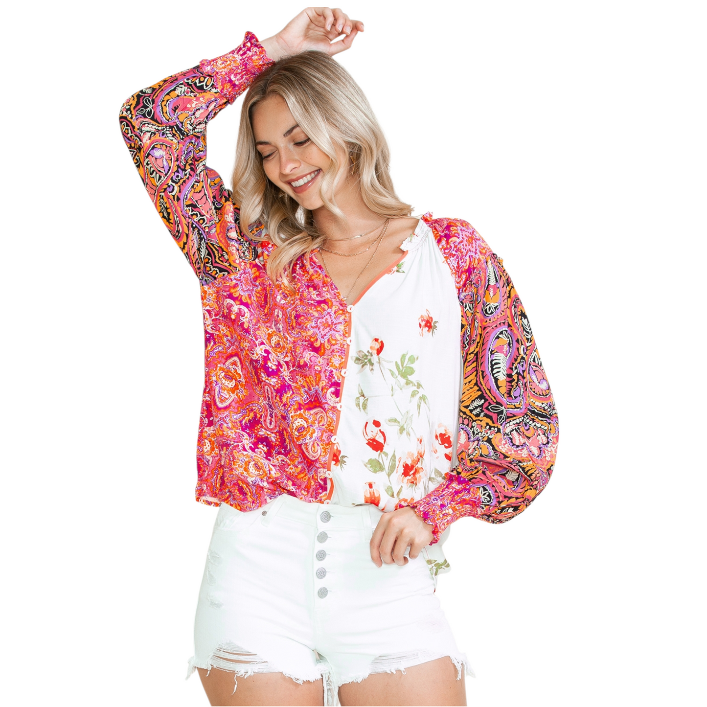 Woman wearing a multi-coloured patchwork floral viscose blouse with a V-neckline and button-down front.