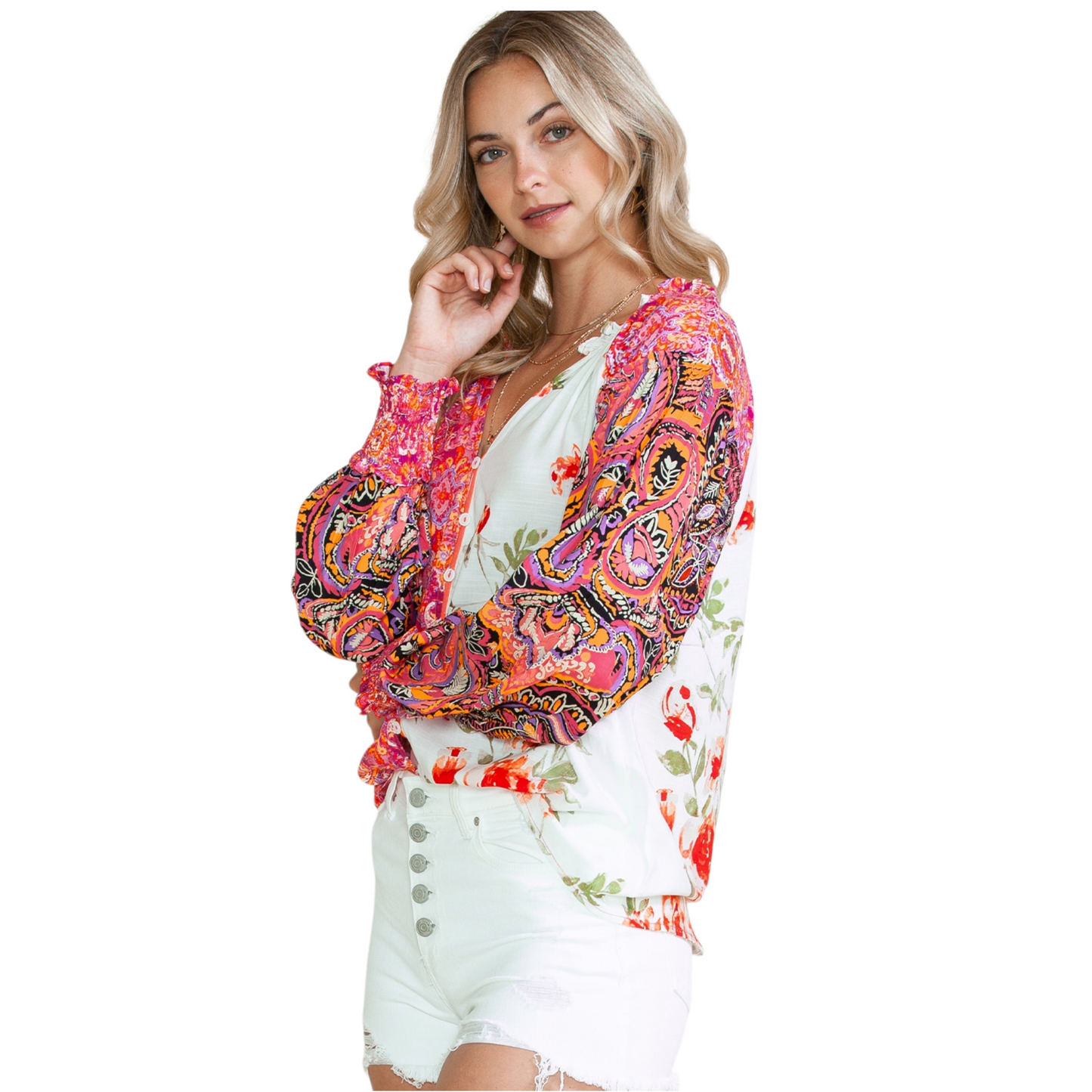 Side view of a woman wearing a multi-coloured patchwork floral viscose blouse with a V-neckline and button-down front.