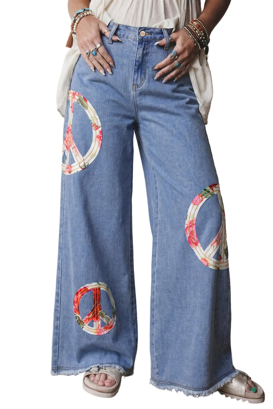 Wide-leg jeans with peace symbol patches worn by a person.