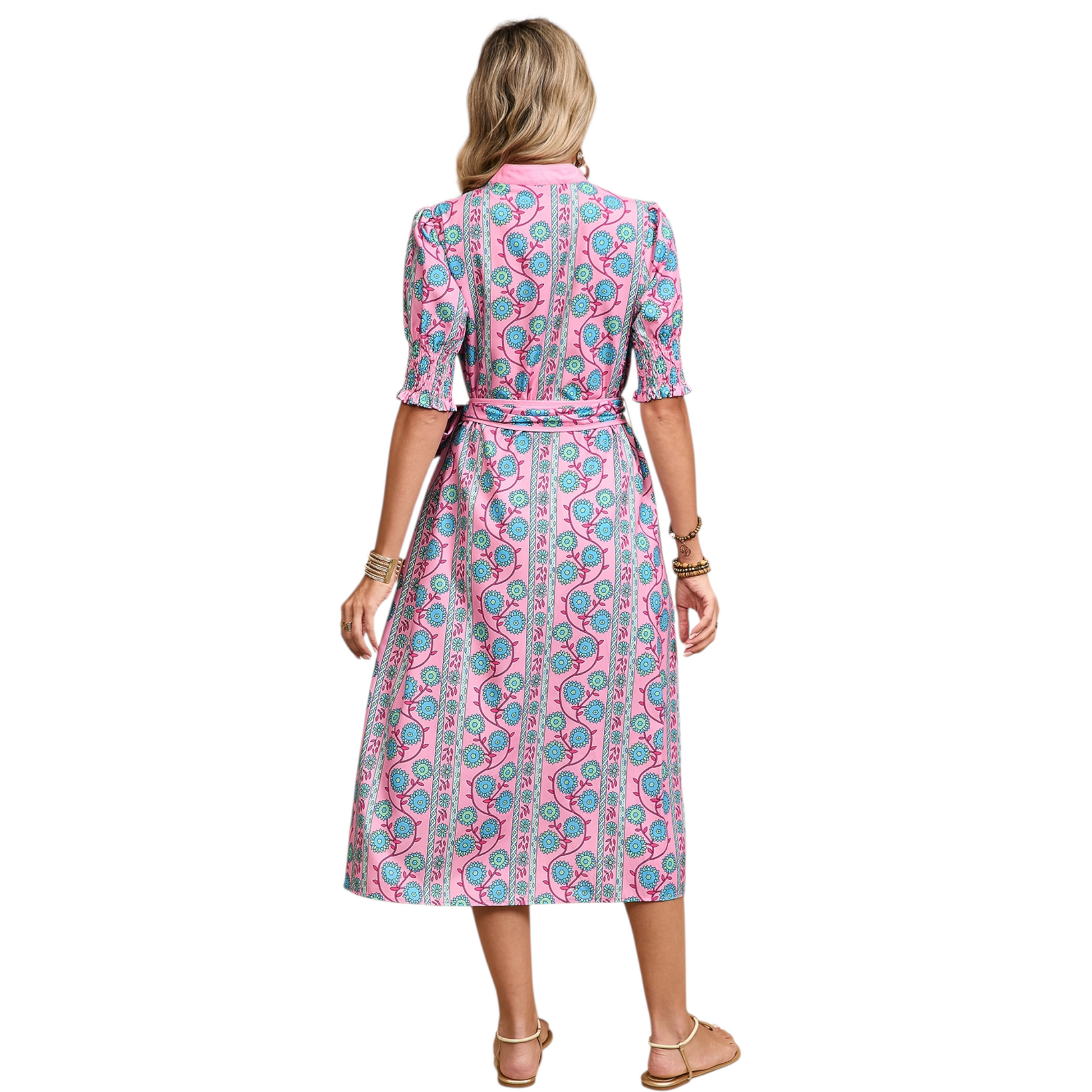 Rear view of a sleeveless white eyelet mini dress showing the intricate embroidery detail, high neckline, and ruffled hemline.