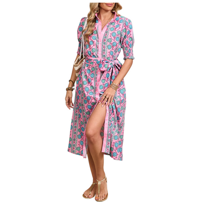 Woman wearing a white sleeveless mini dress featuring all-over floral eyelet embroidery and a tiered ruffle hem.