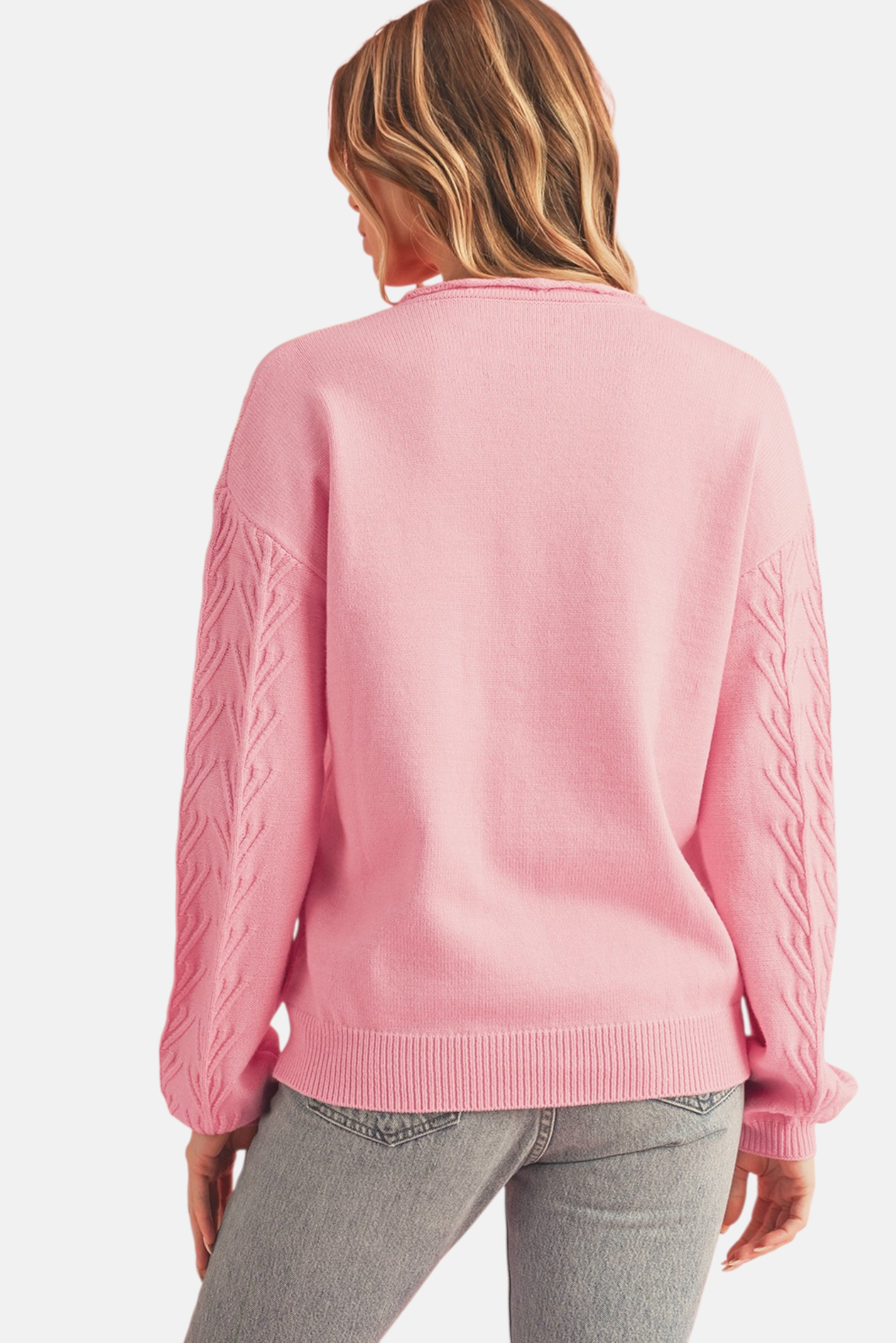 Pink floral embroidery cable sleeve knit sweater front view showing tonal daisy embroidery and notched V-neckline detail