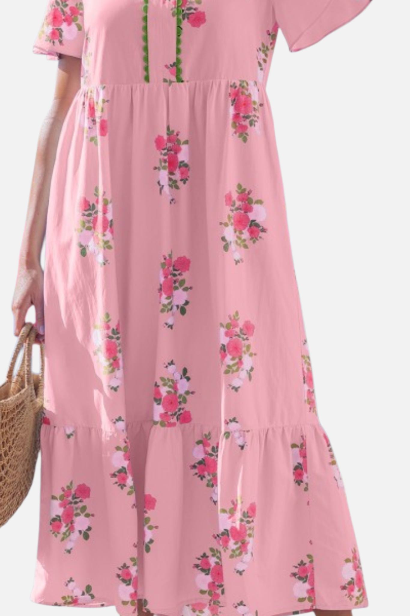 Pink floral dress worn by a person on a white background