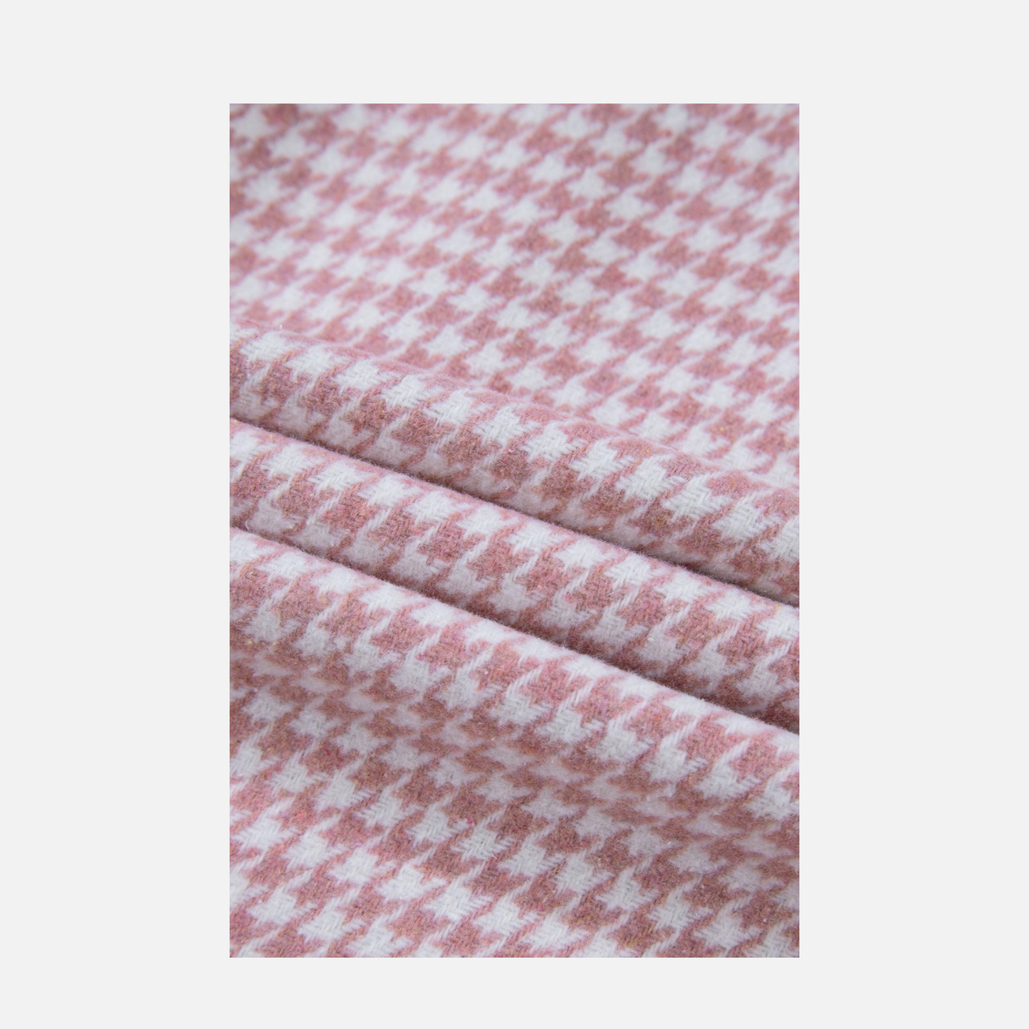 Close-up of pink and white checkered fabric on a light gray background