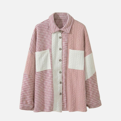 Front view of a pink and white houndstooth and cable-knit patchwork shacket with a button-down front and dual chest pockets.