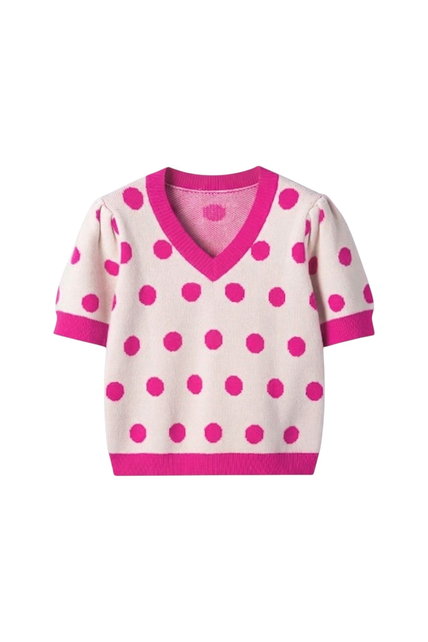 White sweater with pink polka dots on a white background