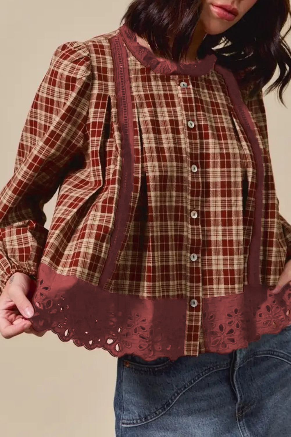 Plaid shirt with lace trim worn by a person against a neutral background