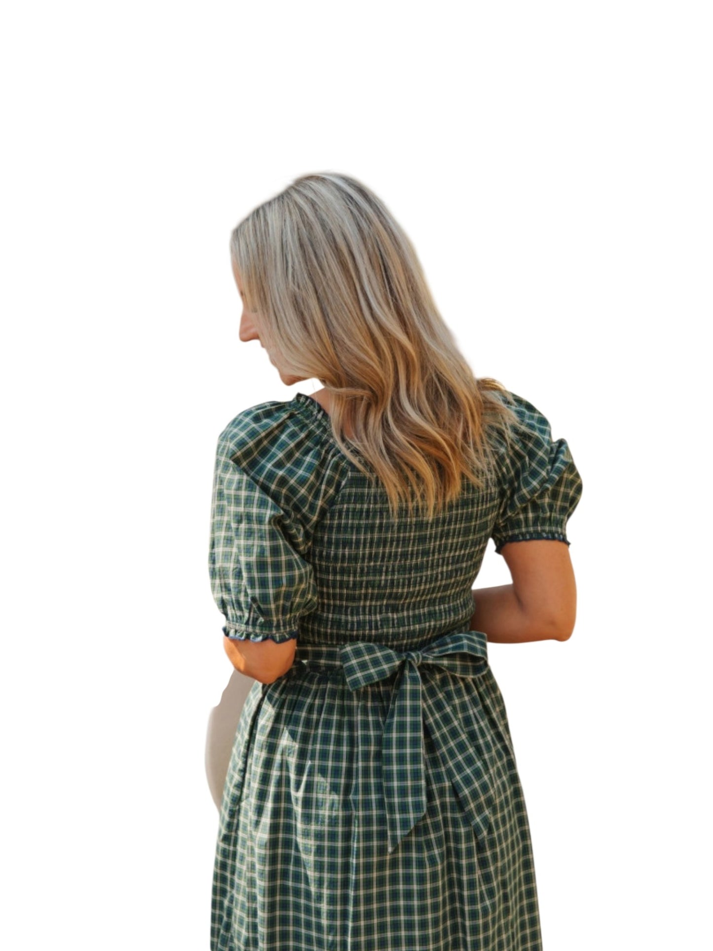 Woman wearing a green checkered dress on a white background back view