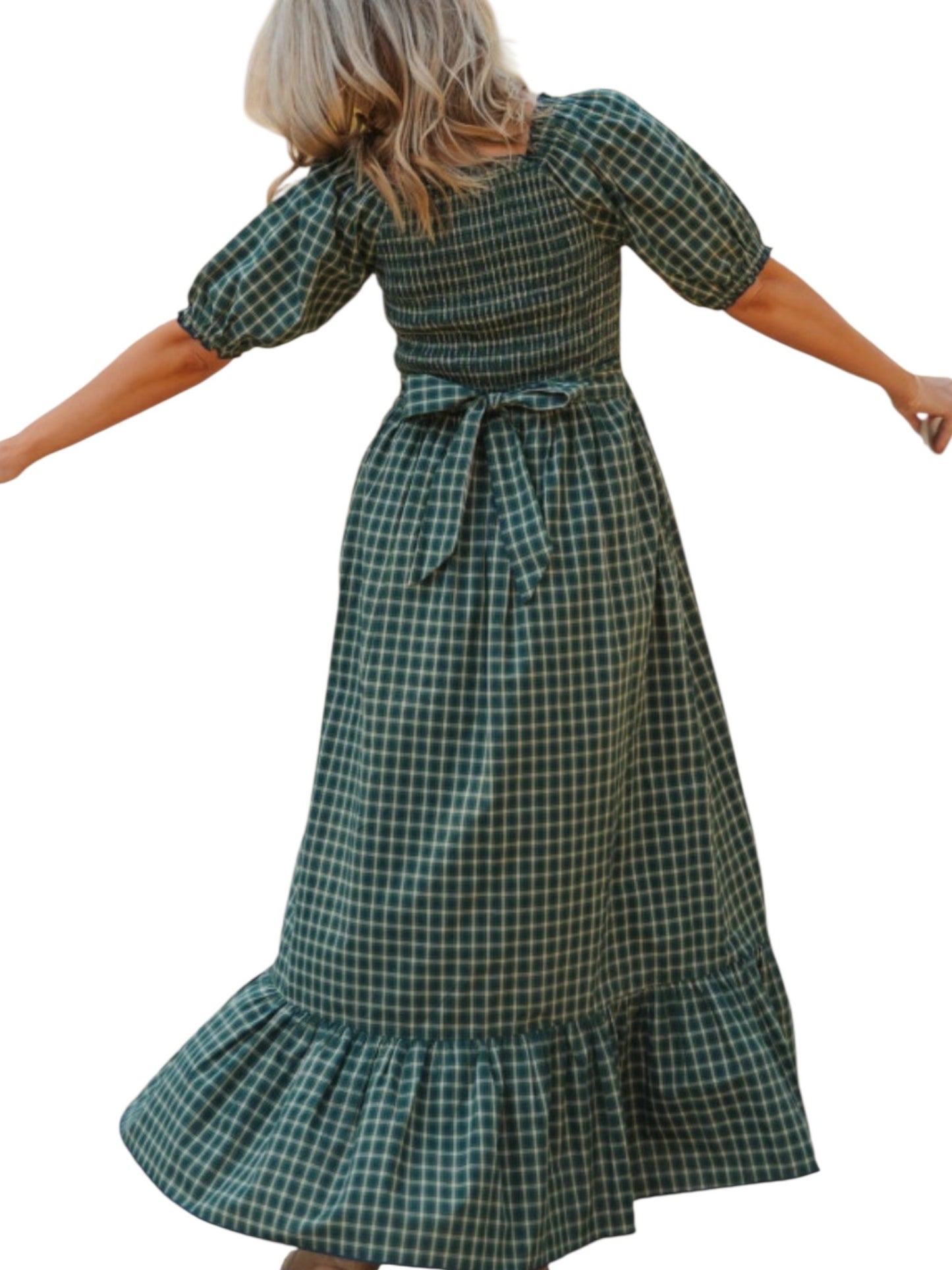 Green plaid dress worn by a person on a white background