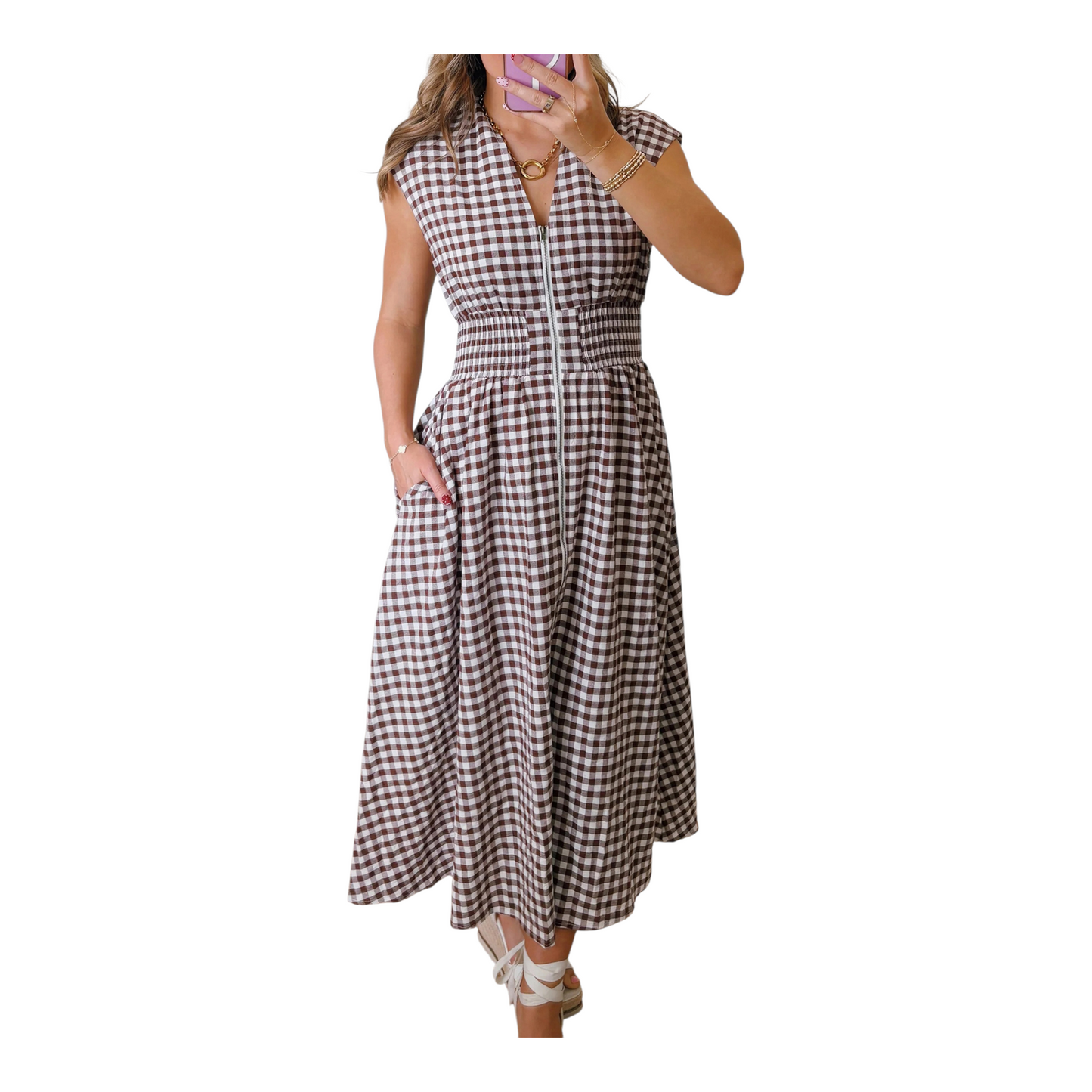A close-up shot of the functional silver-toned front zipper and textured cotton-blend gingham fabric on a smocked waist maxi dress.