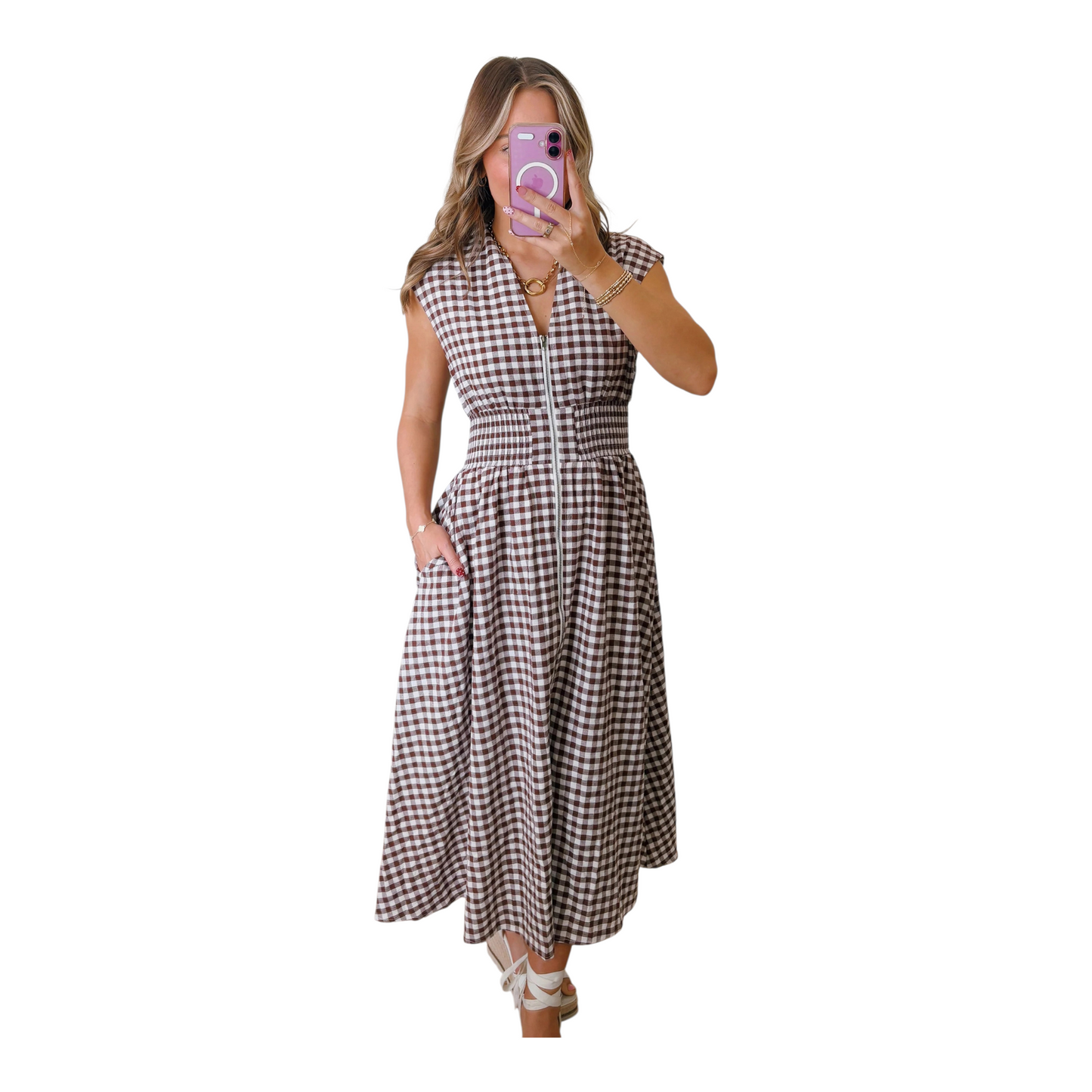 A close-up shot of the functional silver-toned front zipper and textured cotton-blend gingham fabric on a smocked waist maxi dress.