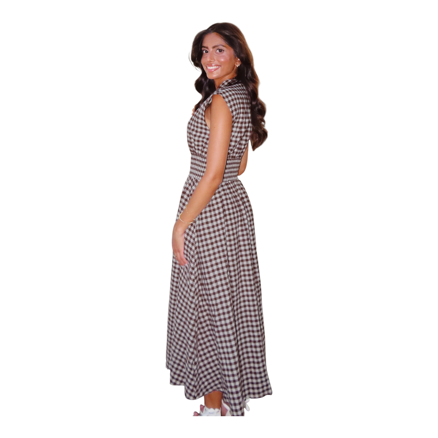 The side view of a sleeveless plaid maxi dress in brown and white, showcasing the relaxed drape and elegant fit-and-flare silhouette.