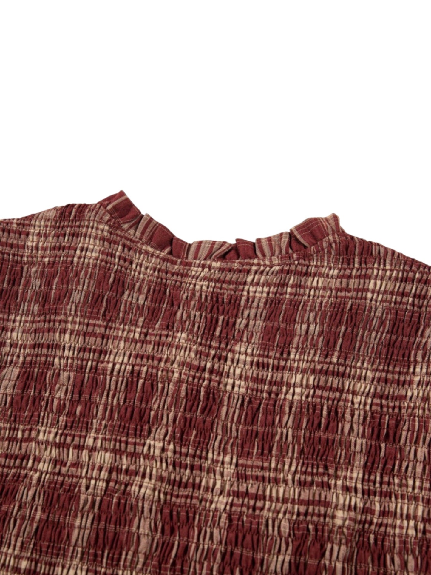 Close-up of a textured, crinkled fabric top in a rust red and beige plaid pattern, featuring a ruffled neckline, shown against a plain white background.