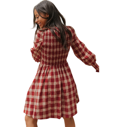 Red and white checkered dress worn by a model on a white background