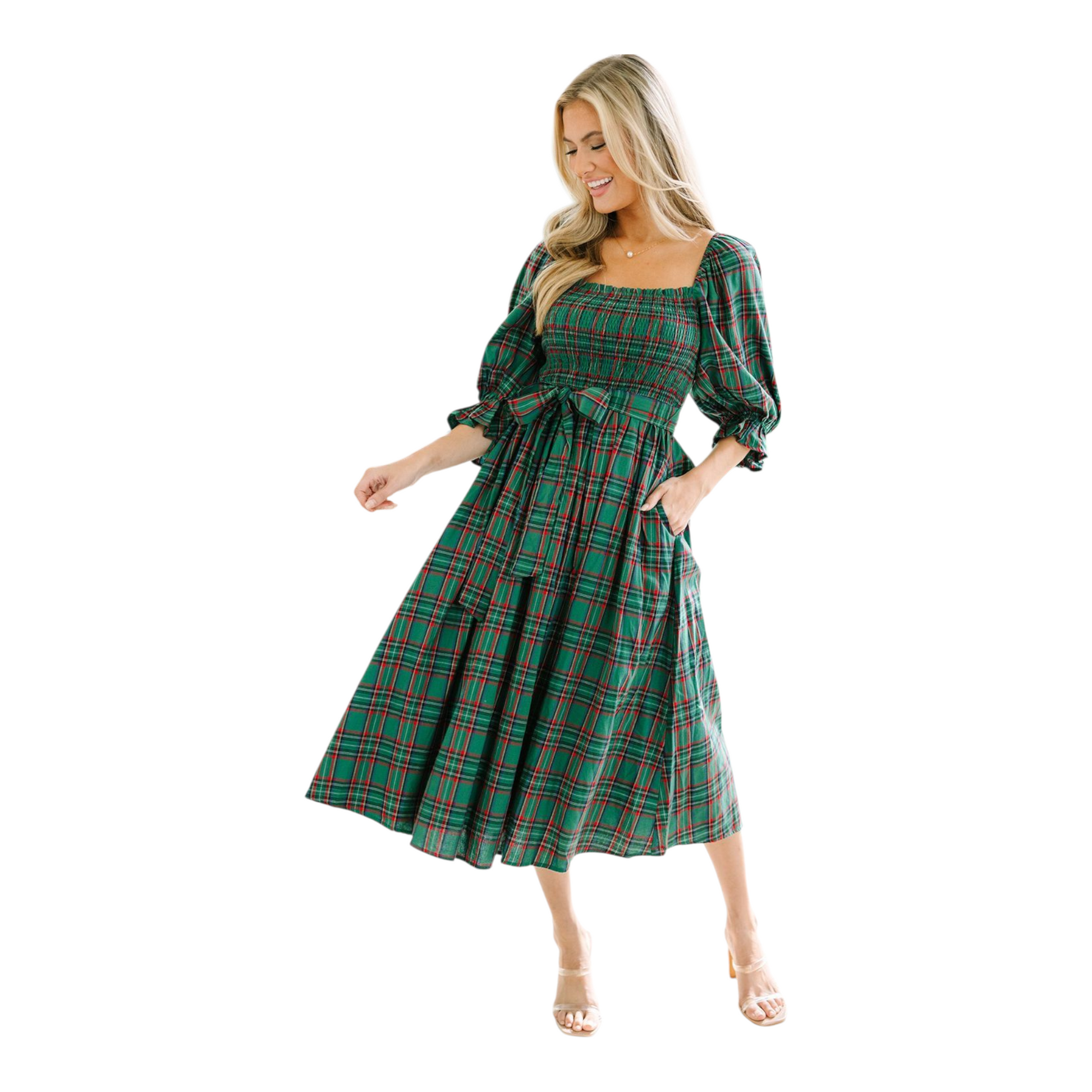 Woman wearing a green plaid dress on a white background
