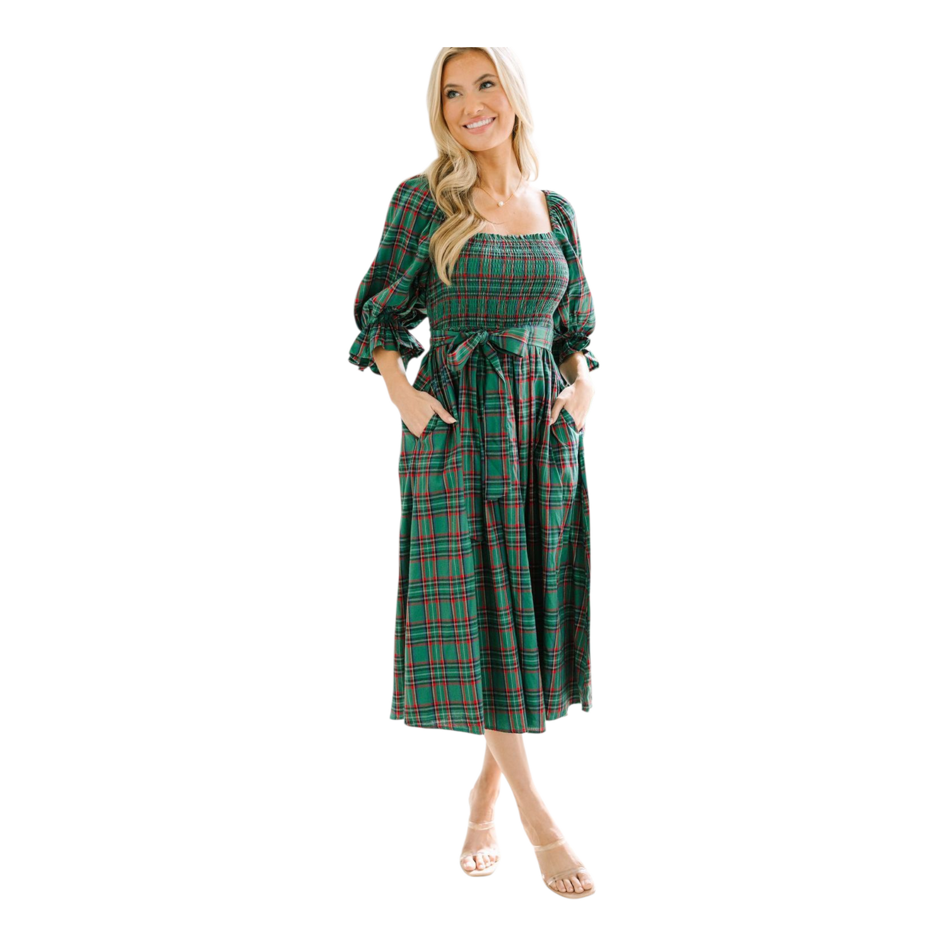 Woman wearing a green plaid dress on a white background