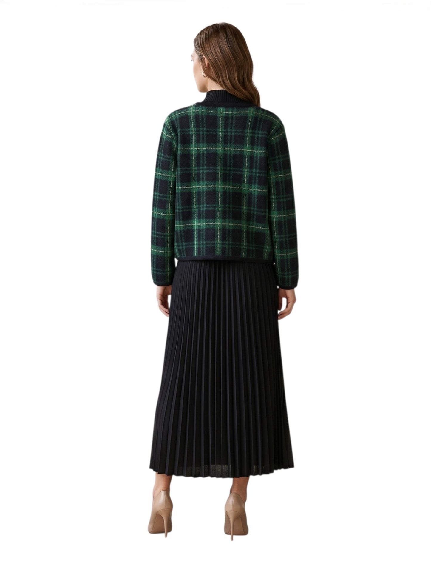 Woman wearing a green plaid shirt and black pleated dress on a white background back view
