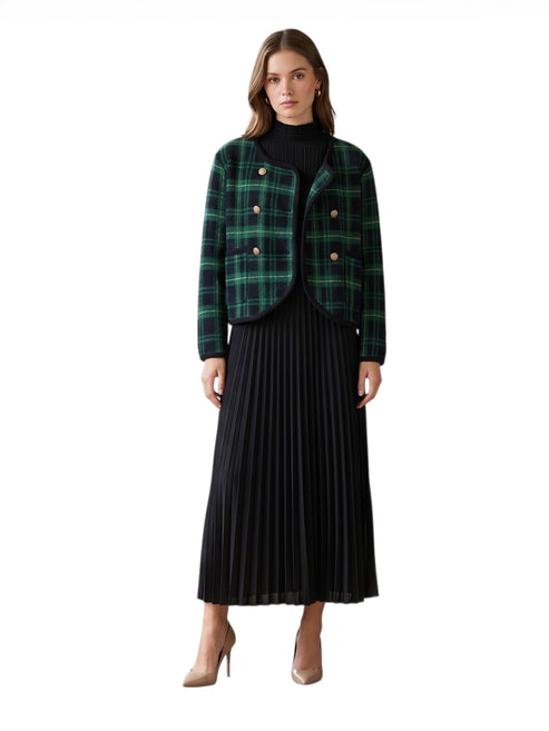 Woman wearing a green plaid jacket and black pleated skirt on a white background front full length view