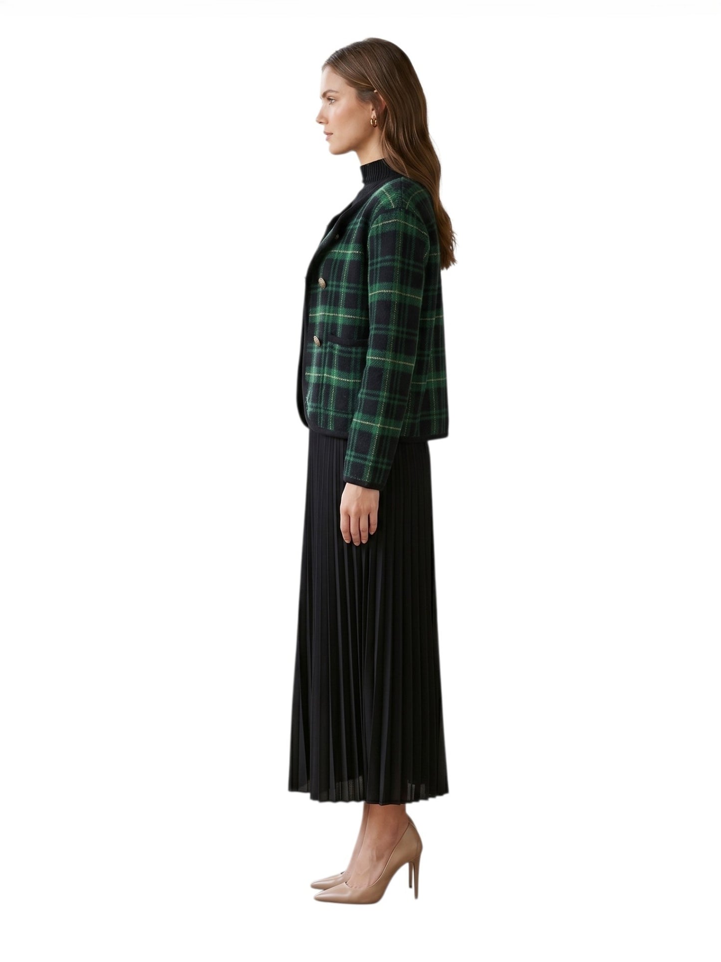 Woman wearing a green plaid jacket and black pleated skirt on a white background side profile view