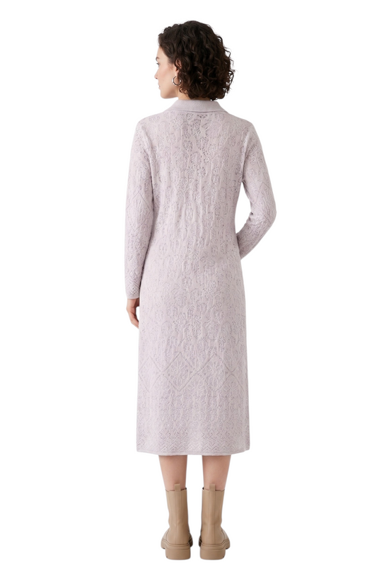 Woman wearing a long light gray dress on a white background