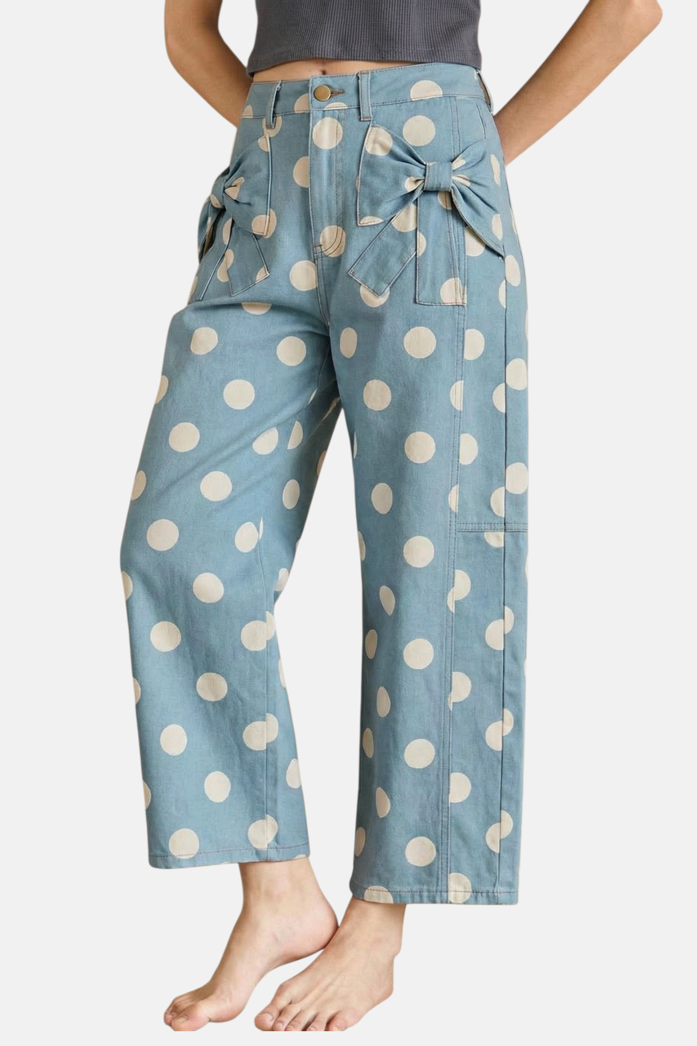 Front view of light blue polka dot jeans featuring unique denim bow accents on oversized front pockets.