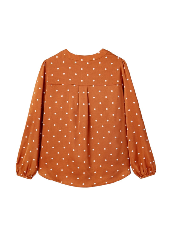 An orange long-sleeve blouse with a white polka dot pattern, featuring a gathered waist seam and elasticized cuffs, shown against a plain white background.