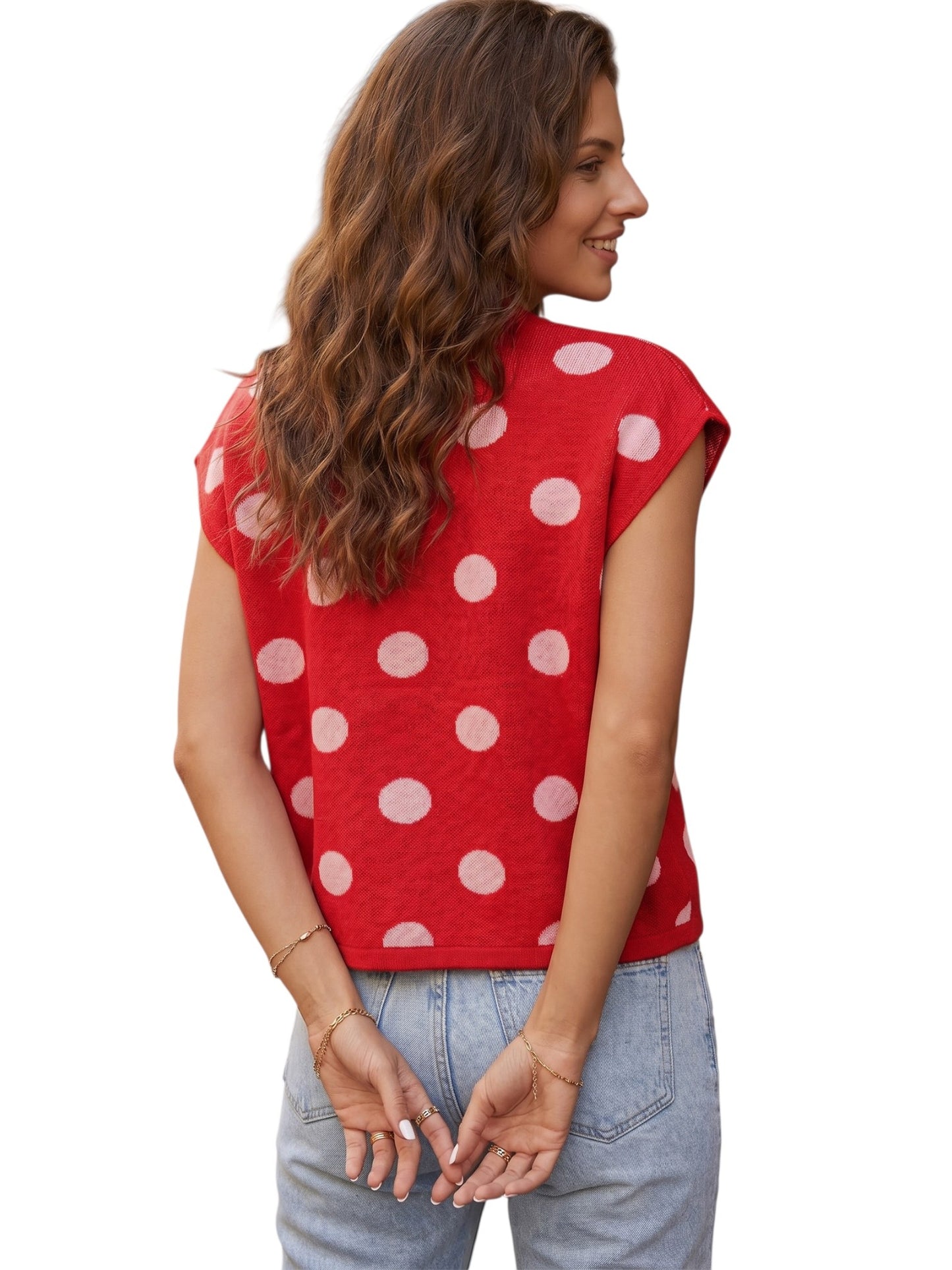 Polka dot button knit top with gold buttons front on model against a white neutral background back view