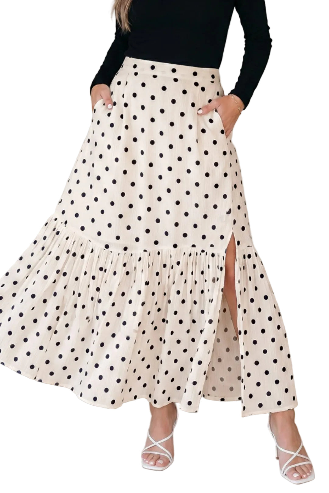 Side profile of a woman wearing a polka dot skirt with side slit against a plain background