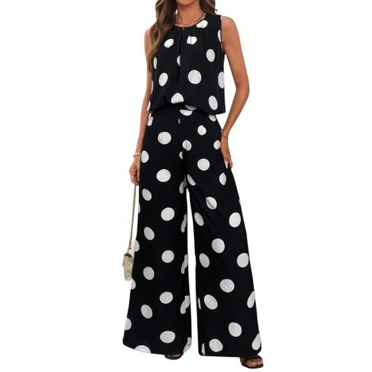 Full-length front view of a two-piece polka dot outfit featuring a relaxed sleeveless top with a pleated neckline and high-waisted wide-leg pants.