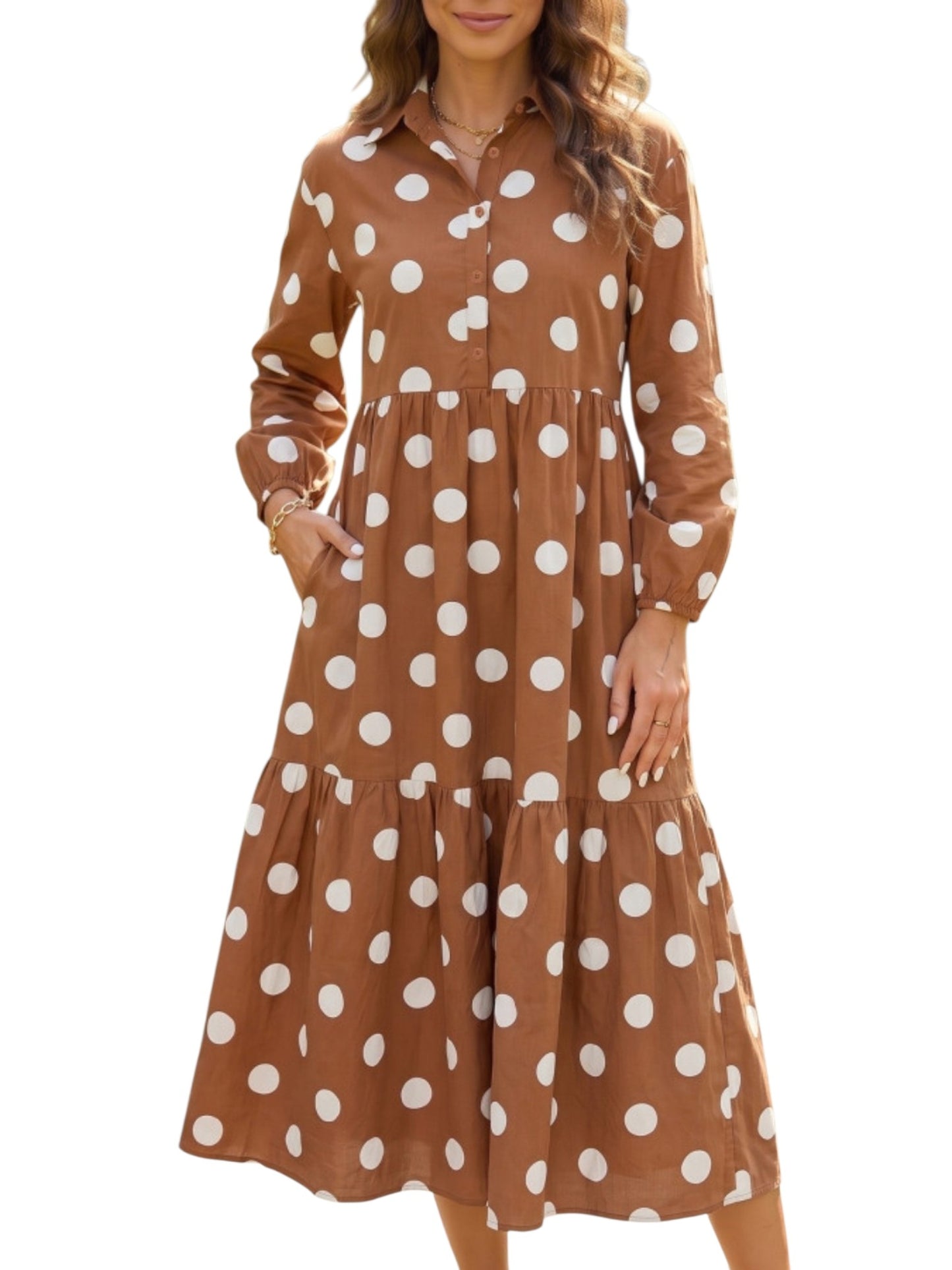 A woman wearing a brown long-sleeve midi dress with a white polka dot pattern, featuring a button-up front and tiered skirt, shown against a plain white background.