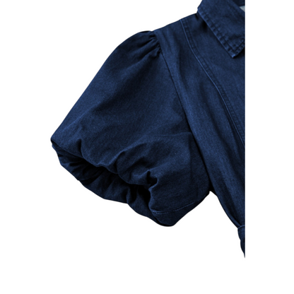 Close-up of the voluminous, elasticated puff sleeve on the deep indigo 100% cotton denim midi dress, highlighting the soft fabric texture and pleated shoulder detail.