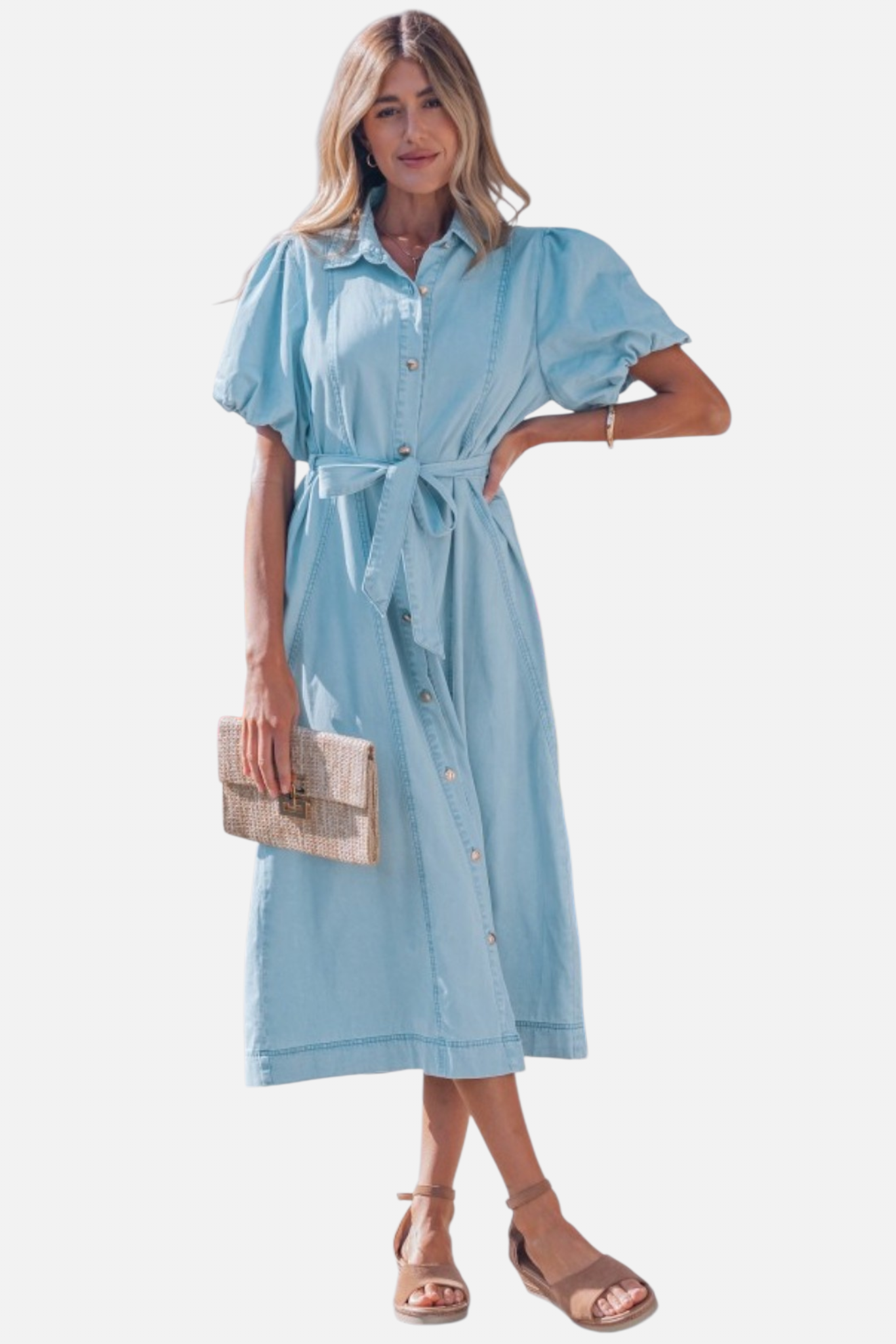 Front view of a model in a light blue denim shirt dress featuring voluminous puff sleeves and a self-tie bow at the waist.