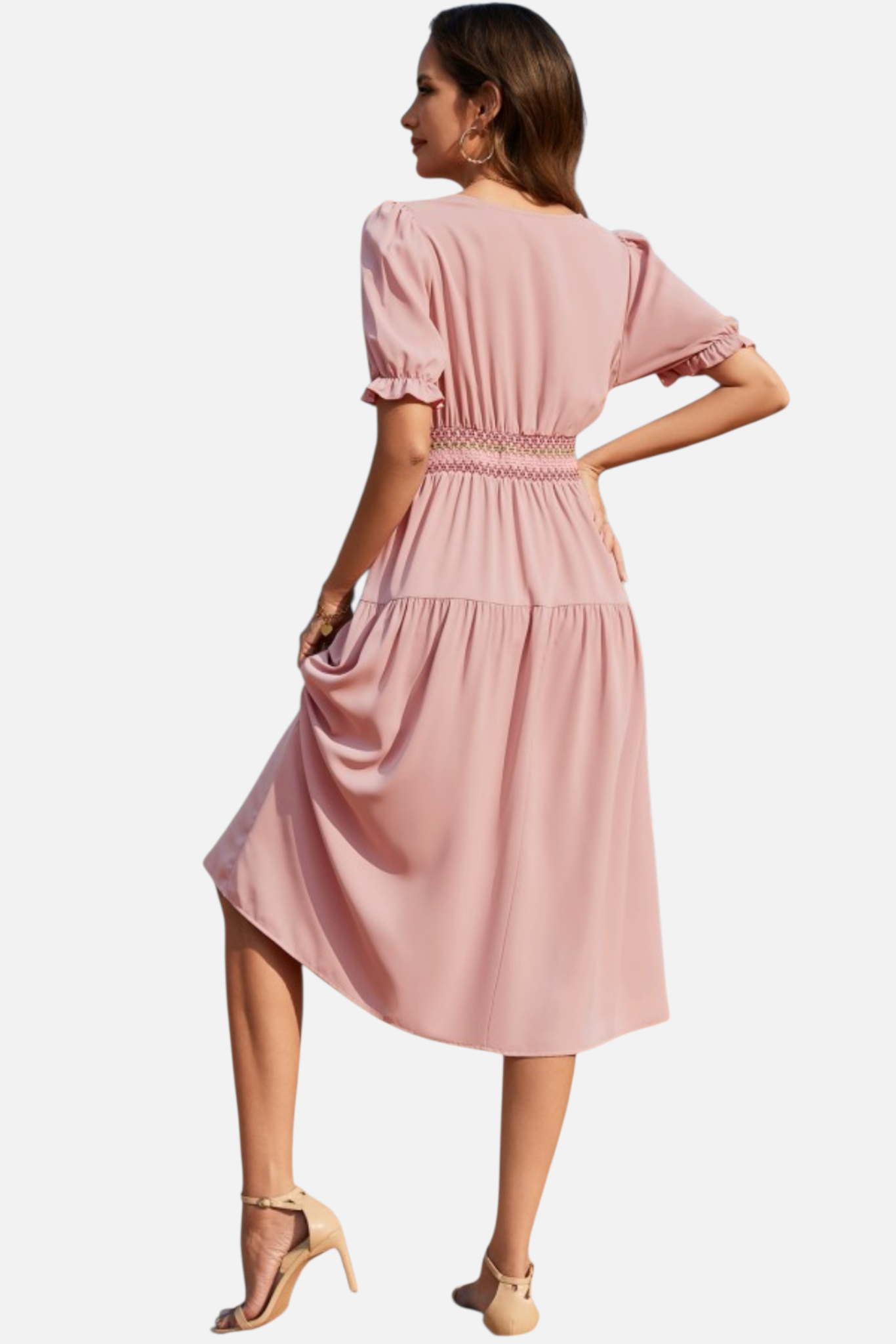 Woman wearing a pink dress on a white background